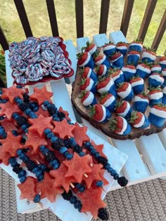 patriotic desserts are displayed on wooden trays