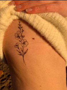 floral tattoo on the rib Violet Flower Rib Tattoo, Feminine Tattoos Side Ribs, Carnation Flower Tattoo Ribs, Violet Rib Tattoo, Hibiscus Tattoo Side Ribs, Ribcage Floral Tattoo, Floral Tattoo Side Ribs, Bunch Of Birth Flowers Tattoo, Water Lily Rib Tattoo