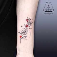 a woman's arm with a flower tattoo on it