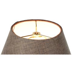 a lamp that is on top of a white surface with a brown shade and gold trim