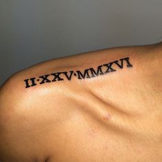 a man's upper arm with roman numeral tattoo