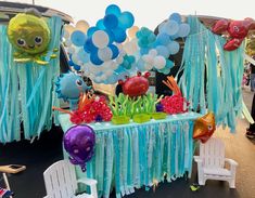 an under the sea themed birthday party with balloons and streamers, fish, and other decorations