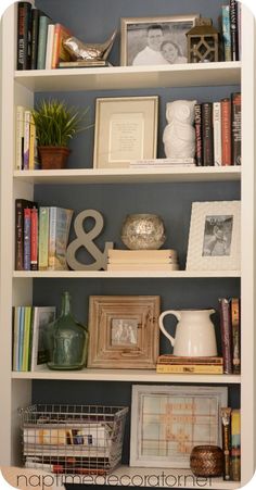 the bookshelf is filled with many different items