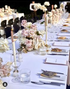 a long table is set with flowers and candles