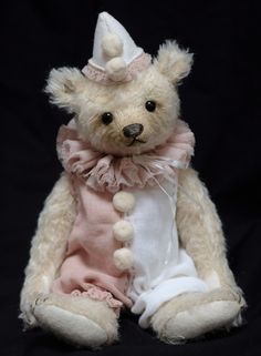 a white teddy bear wearing a pink and white outfit sitting on a black background,