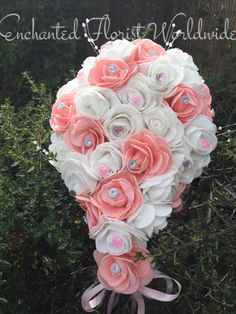 a bridal bouquet with pink and white flowers in the shape of a bride's bouquet