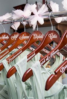 wooden hangers with names on them are lined up