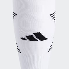 the legs of a person wearing white socks with black and white stripes on their ankles