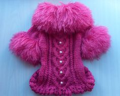 a pink teddy bear wearing a knitted coat