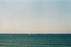 sailboats in the ocean on a clear day