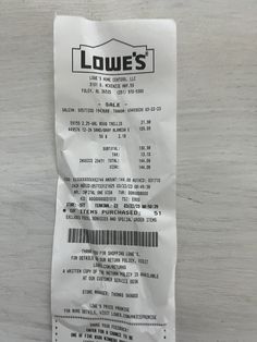 a receipt for a restaurant called low's on a table top with a bar code printed on it