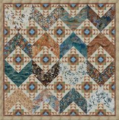 a quilt is shown with many different colors and patterns on the fabric, including blue, brown