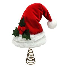 a red and white santa hat on top of a metal spiral christmas tree ornament