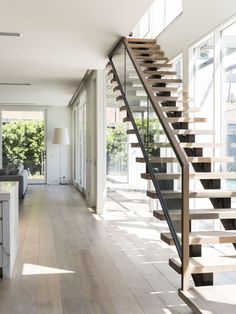 a living room filled with furniture and a staircase