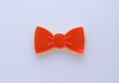 an orange bow cookie on a white background