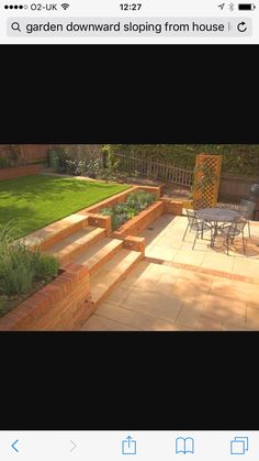 an outdoor patio with steps leading up to the lawn