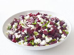 a white bowl filled with beets and feta cheese