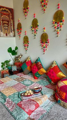 a bed with colorful pillows and decorations on the wall