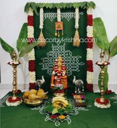 an arrangement of fruits and decorations in front of a green backdrop for a hindu wedding