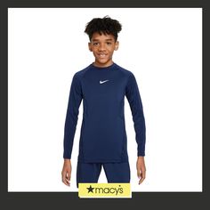 a young boy wearing a blue nike shirt and pants with the name macy's on it