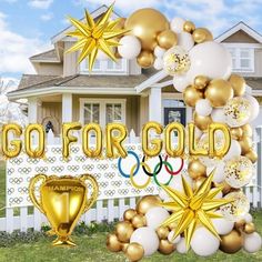 balloons and stars are in front of a house with the words go for gold on it