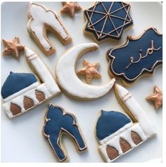 decorated cookies are arranged in the shape of stars, moon, and boots on a plate