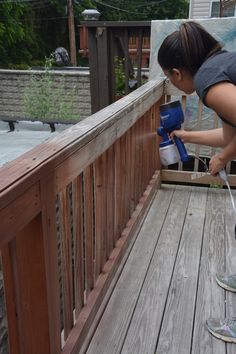 a woman is spraying water on a deck with the words 10 tips for staining your deck