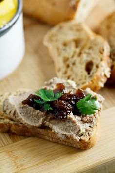 bread with jam and leaves on it sitting on a cutting board next to other breads