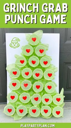 a christmas tree made out of green cups with red hearts on it and the words grin grab punch game