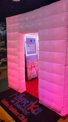 an inflatable booth with a pink light inside