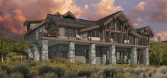 an artist's rendering of a log cabin style home with stone pillars and porches