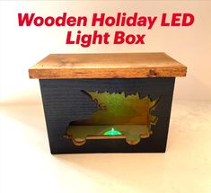 the wooden holiday light box has a green light in it