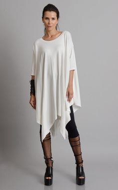 Oversize Long Tunic - METT0105 Be modern in white with this maxi tunic. Because of the loose fit, this top is super easy to wear and perfect for an every day use. It has beautiful asymmetric draping and can easily be paired with a lot of different pants and leggings. Put a pair of heels and a few accessories to make the outfit whole. This asymmetric tunic is made of 100% cotton. NOTE! The color is off white! WHEN YOU PLACE AN ORDER YOU MUST LEAVE A TELEPHONE NUMBER AND CORRECT COORDINATES! WE DO Oversized Tunic Dress, Hand Band, Maxi Pants, Black Linen Pants, Loose Tunic, Maxi Tops, Big Girl Fashion, Black Bracelet, Minimalist Chic