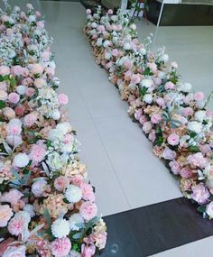 two rows of pink and white flowers on the floor