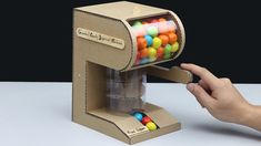 Vending Machine Ideas Diy, Cardboard Gumball Machine Diy, How To Make A Gumball Machine Diy, Diy Suprise Ideas, Mini Vending Machine Diy, How To Make A Vending Machine, Vending Machine Craft, Cardboard Vending Machine Diy, Candy Art Projects