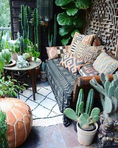 a living room filled with lots of different types of plants and decor on top of each other