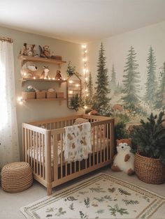 a baby's room with a teddy bear in the crib and christmas trees on the wall