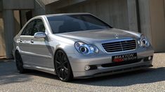 a silver car parked in front of a building