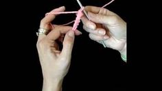 two hands are holding yarn and knitting needles