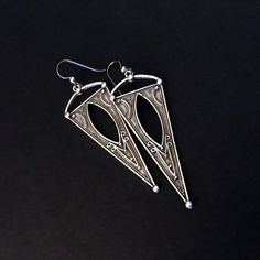 Silver plated, embossed, triangle shaped earrings - Silver plated, embossed Zamak triangle shaped dangles - from EU - Niobium and Sterling silver ear wires - Top of ear wire to bottom of dangle measures 3-in - Side to side at widest point of dangle measures approximately 1-in - Clear rubber stoppers included *These earrings are so beautiful and super lightweight! Etched Metal Drop Earrings, Bohemian Triangle Nickel-free Earrings, Nickel Free Triangle Metal Earrings, Nickel-free Metal Triangle Earrings, Jewelry Silver Earrings, Jewelry Chunky, Silver Diamond Necklace, Silver Rings Simple, Chunky Earrings