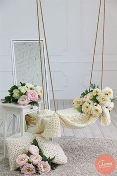 a white chair with flowers on it next to a mirror