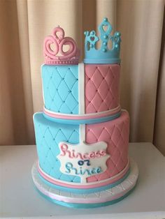 a three tiered cake with princess crowns on top