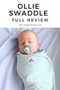 a baby sleeping in a blue swaddle with the words ollie swaddle full review