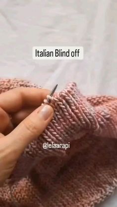 a woman is holding a knitted cloth with a needle in it and the words italian blind off above her