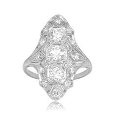 an antique style diamond ring with three stones in the center and two rows of diamonds on each