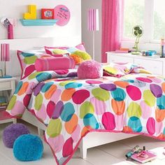 a bed room with a neatly made bed and lots of colorful decorations on the walls