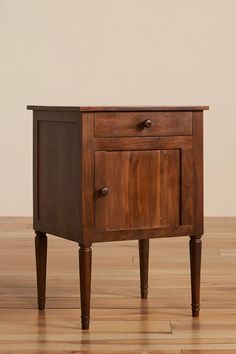 a wooden cabinet with two drawers on one side and an open drawer on the other