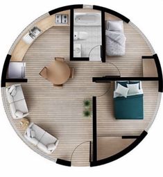 an overhead view of a bedroom and living room in a round house with wood flooring