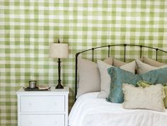 a bedroom with green and white checkered wallpaper