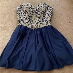 Navy Blue With Gold Detail And Sparkles. Strapless, Sweetheart Neckline. Says Size 3 On The Dress But Poskmark Doesn’t Have That As An Option! Navy Blue And Gold Dress, Strapless Homecoming Dresses, Strapless Sweetheart Neckline, Davids Bridal Dresses, Davids Bridal, Homecoming Dress, Dresses Strapless, Quince, Gold Details